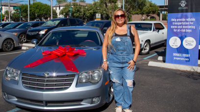 Phoenix College Nursing Student Jacquelina Reyes stands next to a the car she received as part of a JC Supercar Giveaway