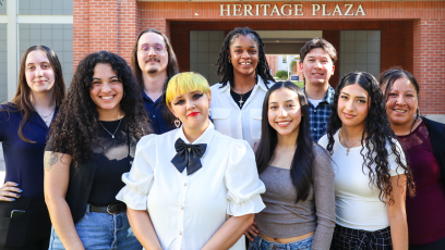 Nine PC Ambassadors posing in front of Heritage Plaza on campus