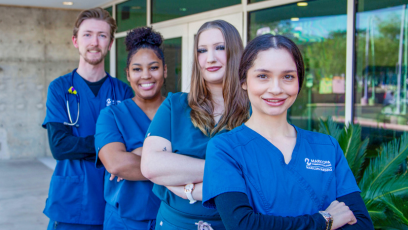 Four nursing students standing outside nursing building