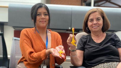 PC staff members holding up two rubber chicken