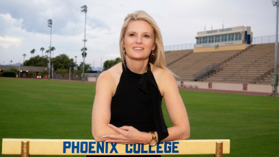 Dr. Kimberly Britt standing behind a track hurdle at Hogan Field