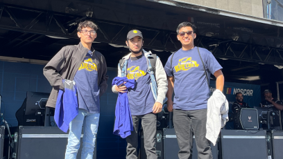 Esports participants–Angel, Adriel, and Miguel–standing at the Phoenix Raceway