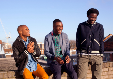 Three black men gather as part of a Phoenix College initiative to uplift men of color on college campuses