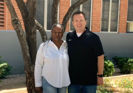 Donna Gammage and Bryan Heckler stand in front of Phoenix College's E building where the TLC homeroom is housed. 