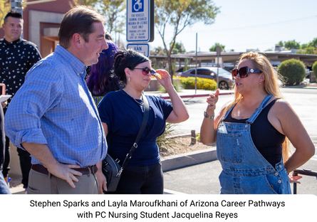 Phoenix College Nursing student Jacquelina Reyes stands next to PC Mascot Bumbstead the Bear and Aaron Trudeau and Chuck Rash of JC Supercars