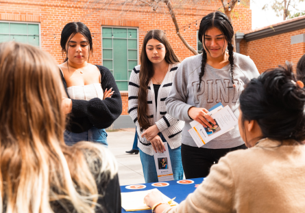 Hermanas participants gather information during the resource fair on Phoenix College's campus