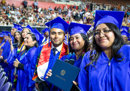Three Phoenix College students posing for a photo at Commencement