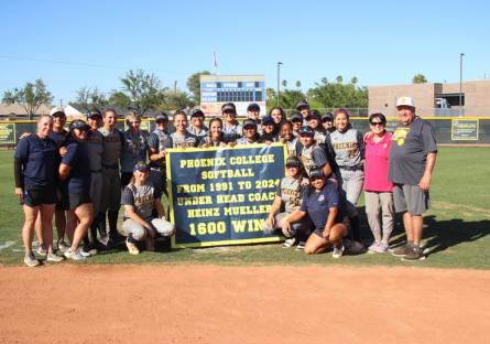 Phoenix College Softball Head Coach Heinz Mueller standing with staff and current team celebrates his 1600 win