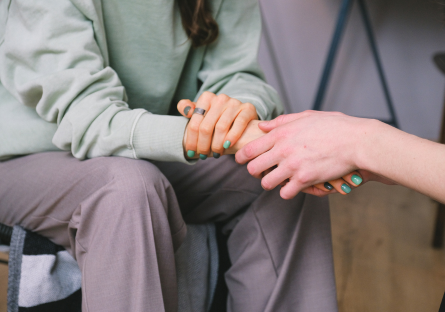 hands holding in a counseling session