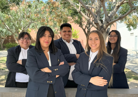 PC United Executive Board (5 students in navy blazers standing outside)