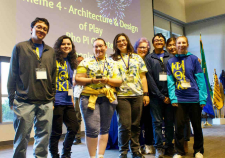 PC’s Rho Pi Chapter students holding their award