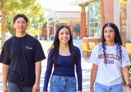 Three students walking on campus