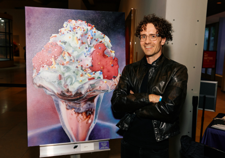 Phoenix College art student Nick Erickson stands next to his digital art "Confetti," which won a  2025 Vanguard award
