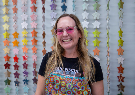 Ceramics Faculty Tiffany Bailey stands in front of the stars she built, glazed and fired for the Phoenix College Ceramics studio