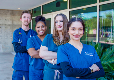 Four nursing students standing outside nursing building