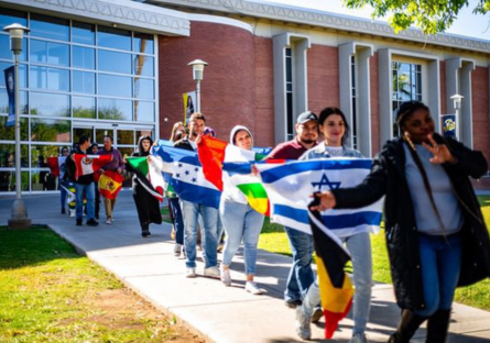 Phoenix College students and staff carry the flag of their home country