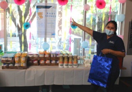 Student in front of Baby Shower table
