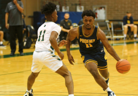 Two basketball players on a court - subject of story (Mike) dribbling