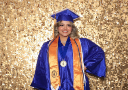 PC graduate, Ingrid in blue and gold Commencement regalia