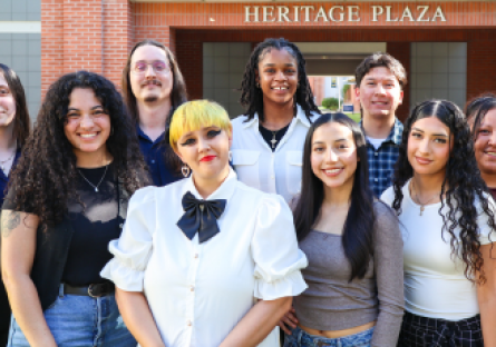 Nine PC Ambassadors posing in front of Heritage Plaza on campus