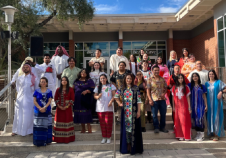 Phoenix College student model traditional clothing from around the world during Arizona International Education Week