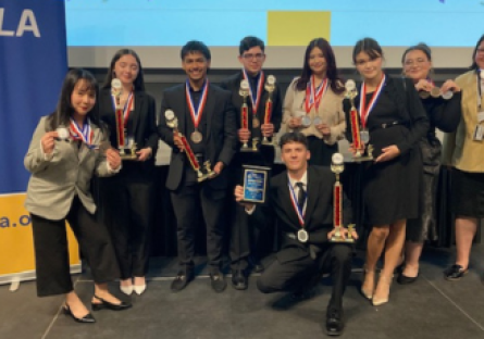 Phoenix College Future Business Leaders of America students with their competition medals and trophies.