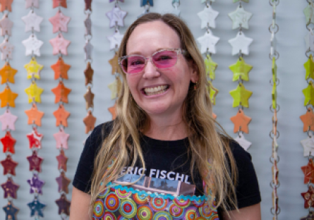 Ceramics Faculty Tiffany Bailey stands in front of the stars she built, glazed and fired for the Phoenix College Ceramics studio