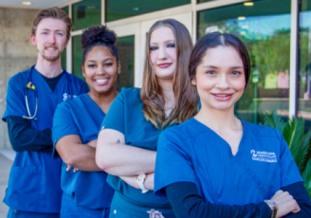 Four nursing students standing outside nursing building