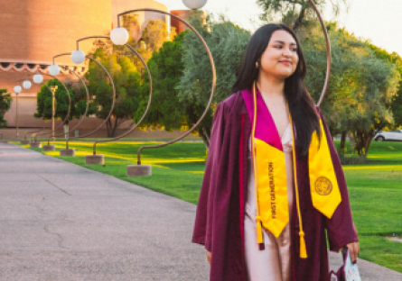 Education major Alejandra Vega at her ASU graduation wearing a grad robe and carrying her cap. 